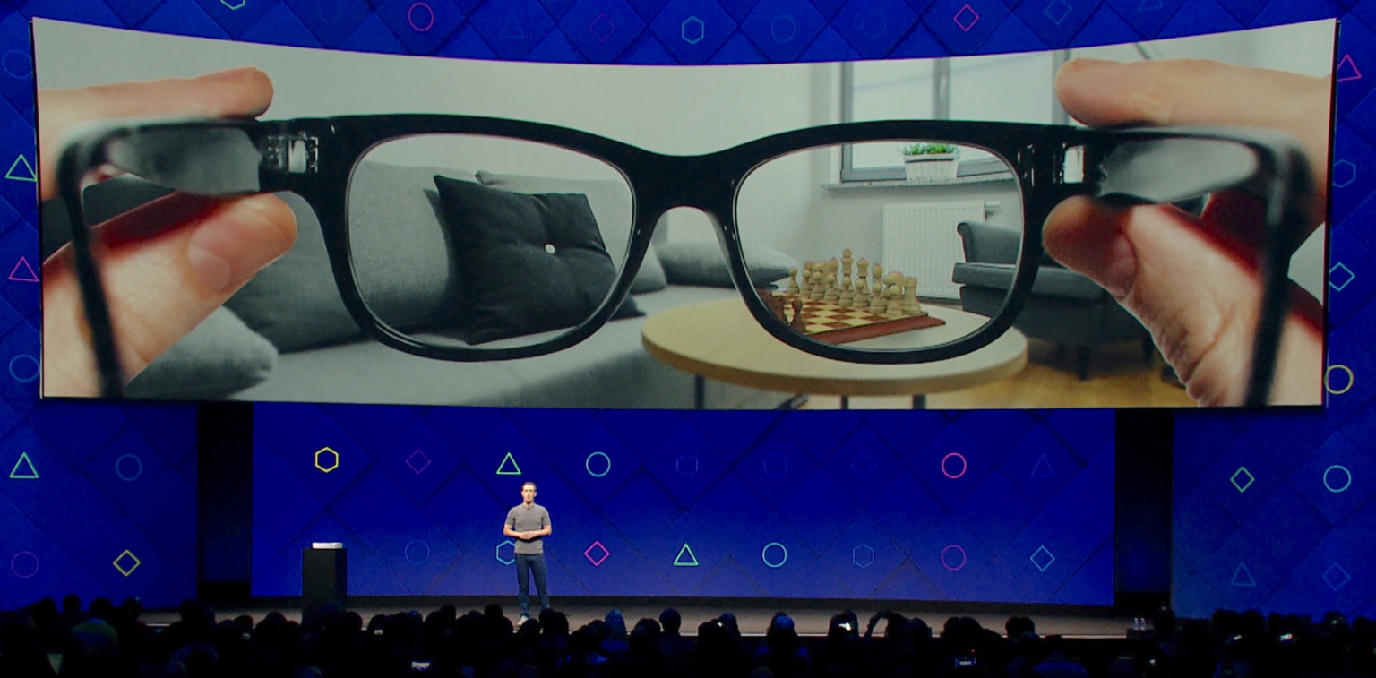 A photo of a presentation showing concept art of a pair of AR glasses.